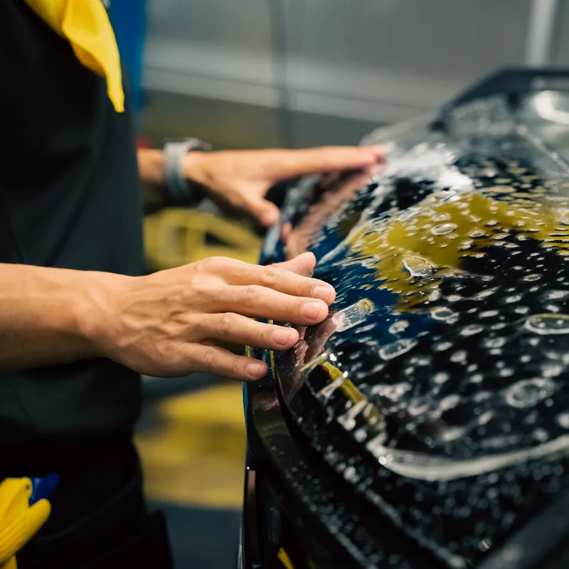 Installer smoothing paint protection film by hand